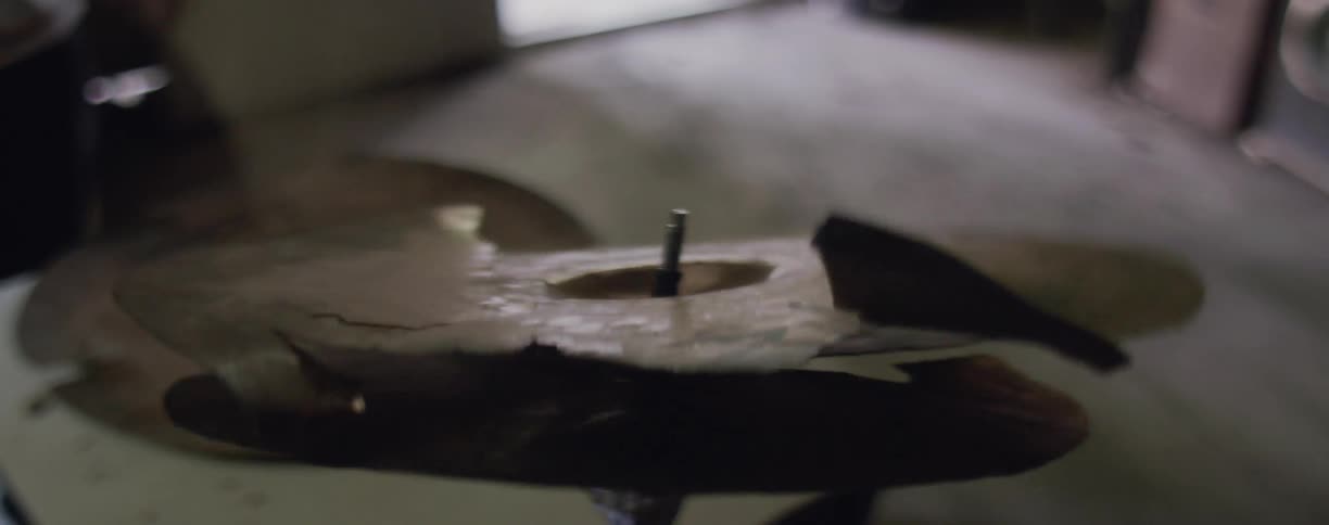 A drummer is breaking the cymbal as he plays