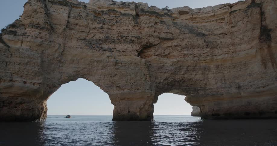 Water flows under a large formation of rock