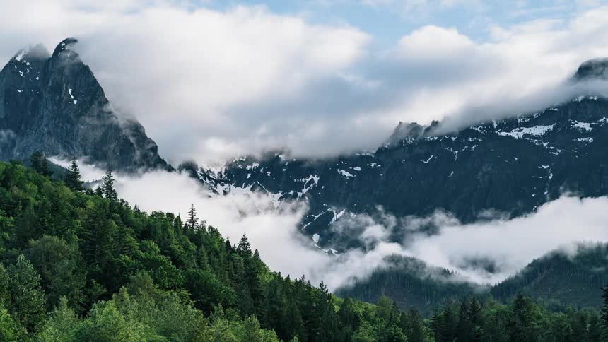 Clouds float over mountains and trees - 4K Time Lapse