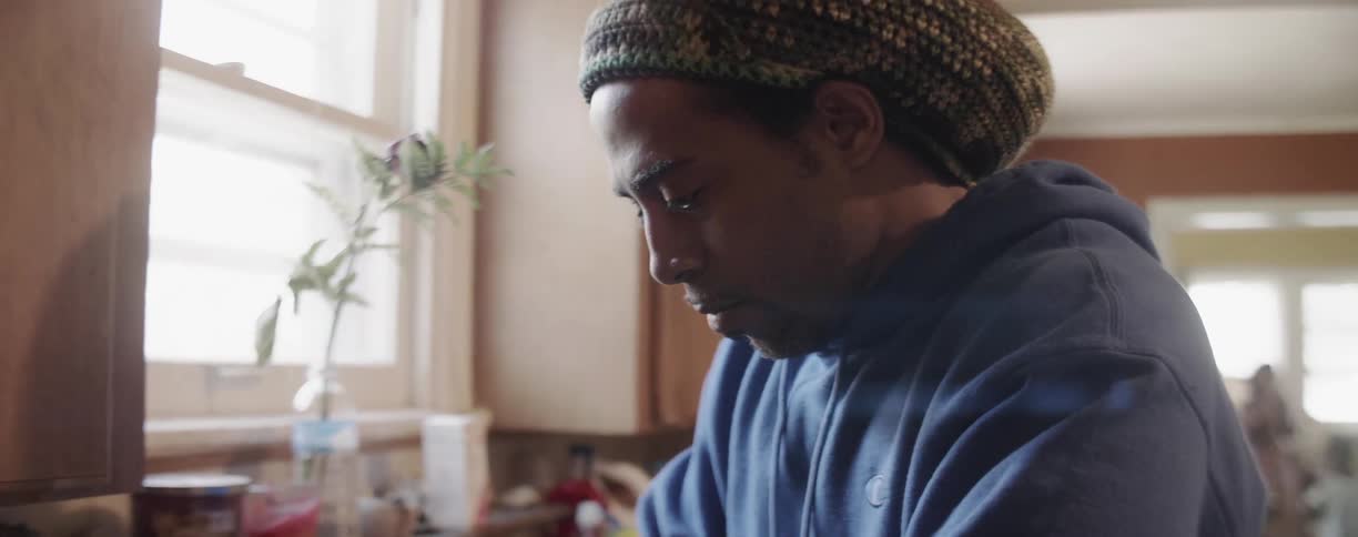 A man washes dishes in the kitchen
