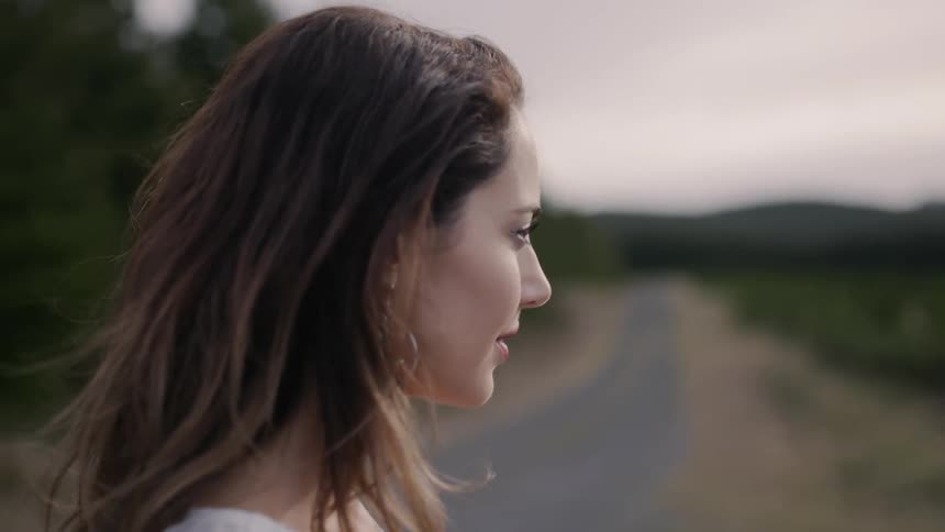 Woman walks down a country road