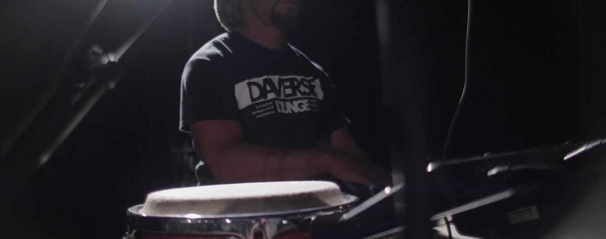 A man plays the drums with his hands