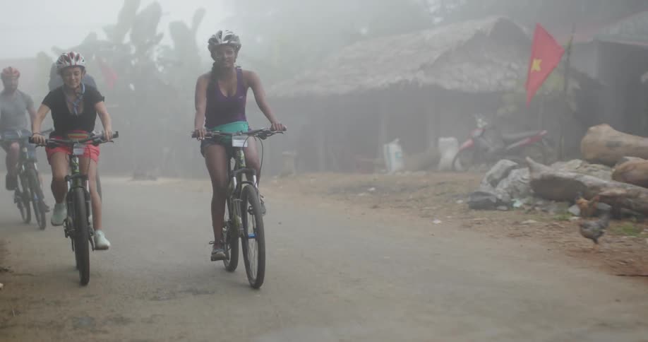 A group of people ride bikes together