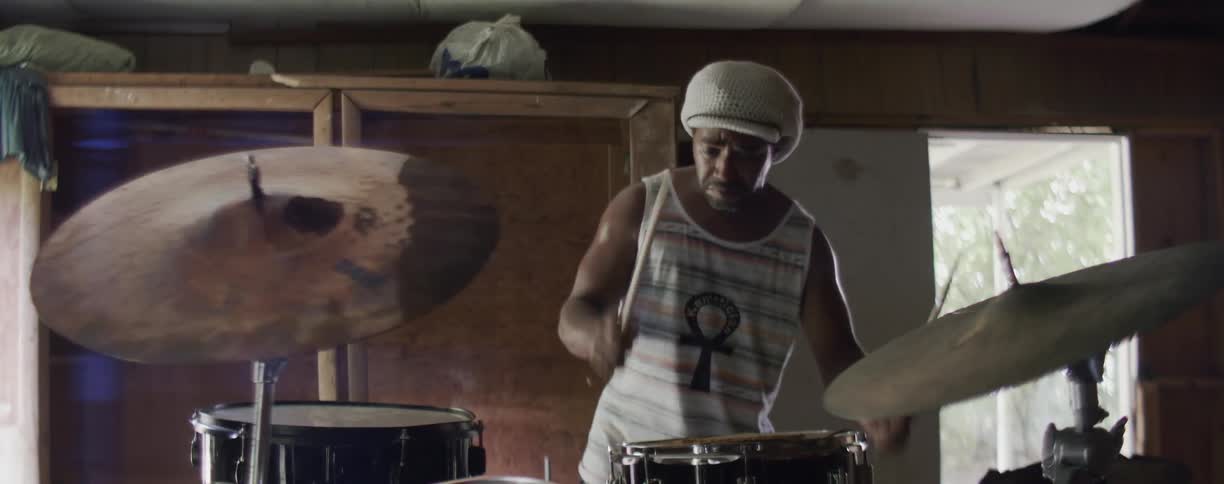 Man plays a set of drums
