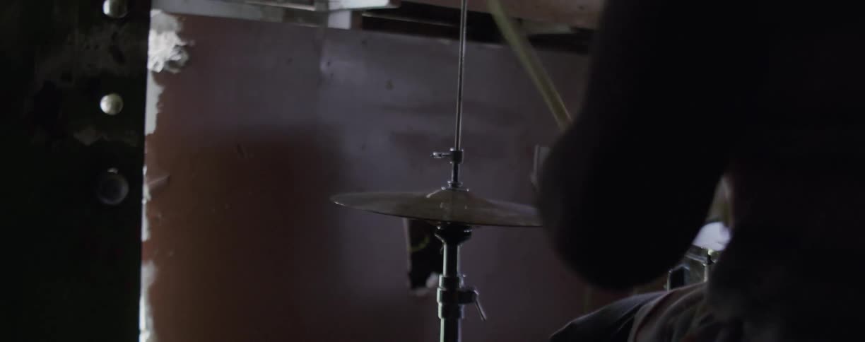 Man plays a set of drums