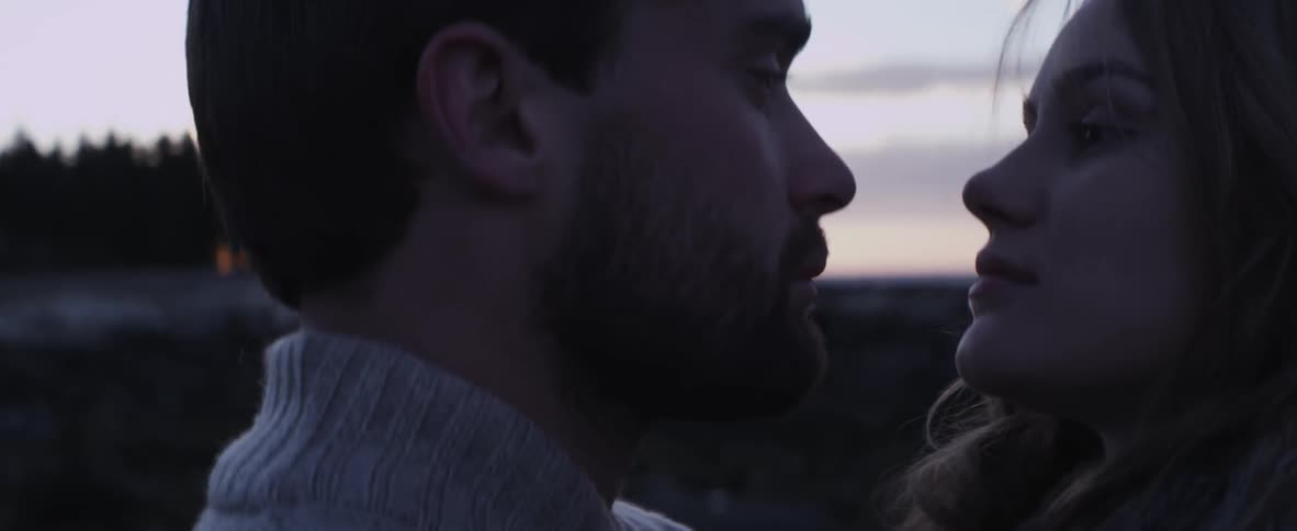 A man and woman holding each other outside