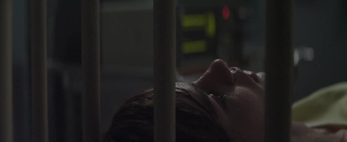 A sweaty woman laying in bed