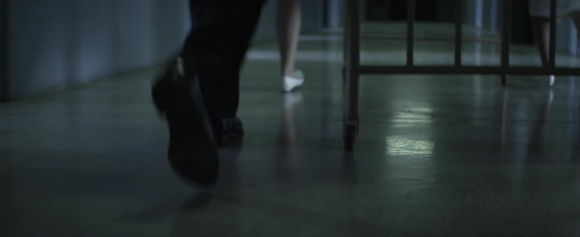 A nurse and doctor running with a hospital bed