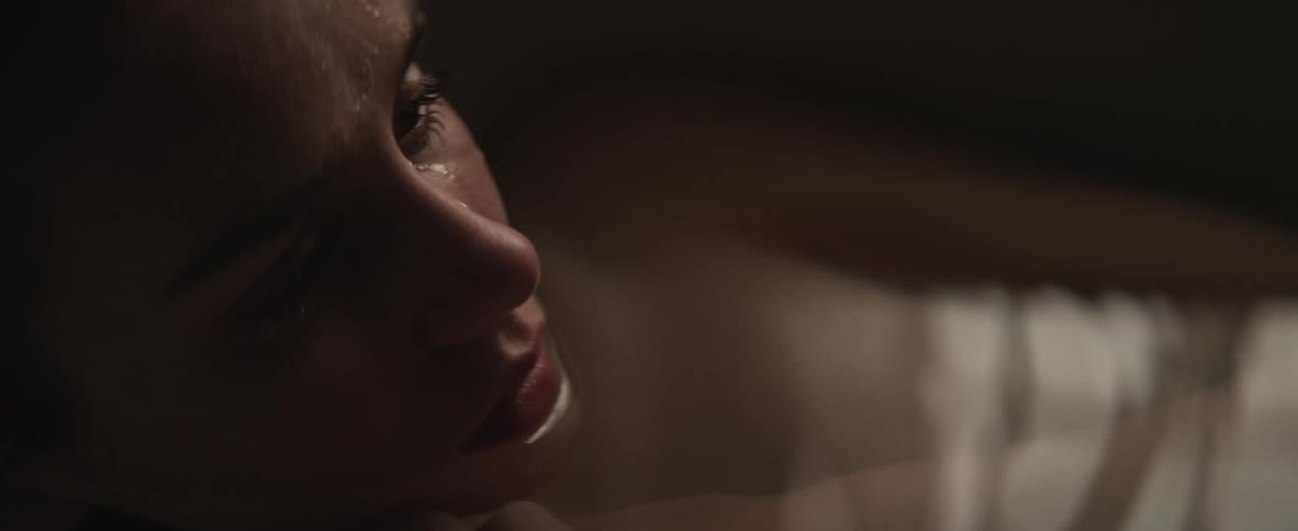 A woman laying in a bathtub