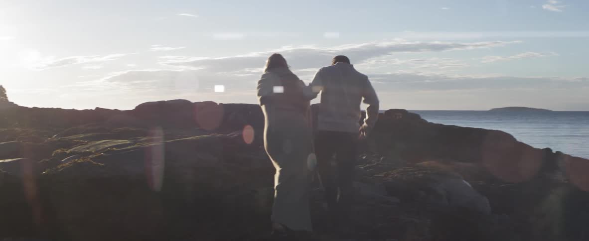 Man and woman walking towards the top of a hill
