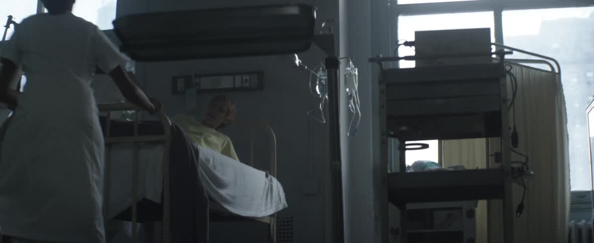 A pregnant woman being wheeled on a bed in a hospital
