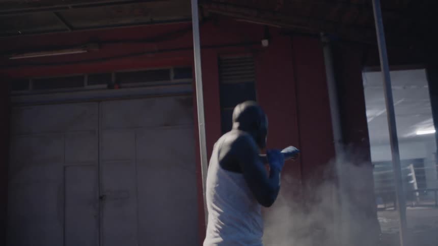 A man is boxing out in the alley