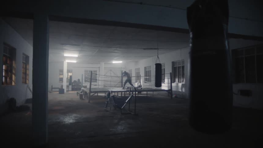 A man is shadowboxing in the ring
