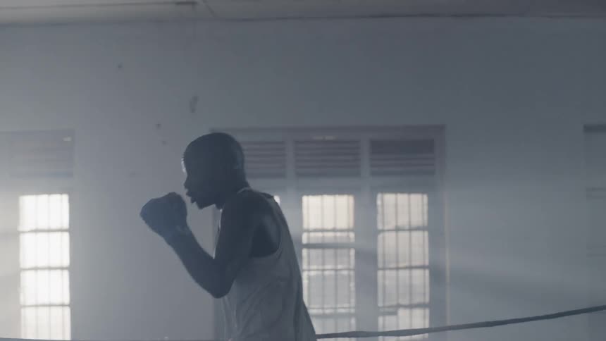 Man punches the air in a boxing ring