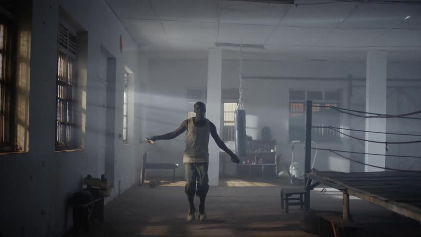 Man is jumping rope in a gym training room