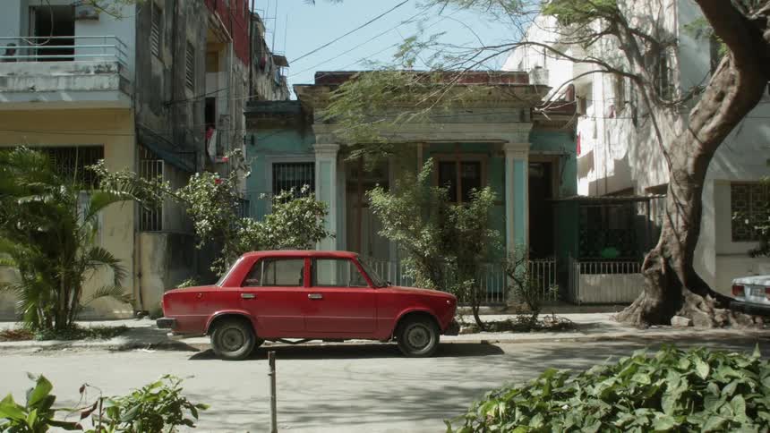 Man runs past red car