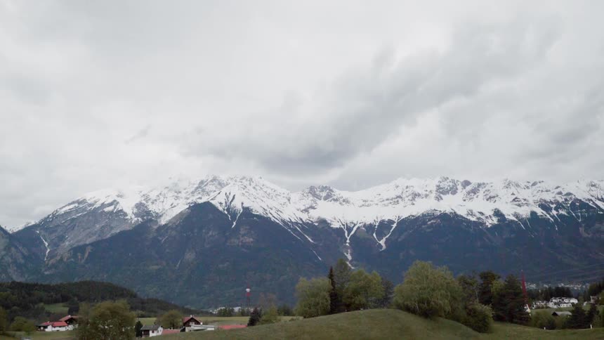Clouds hang above the snow capped mountain