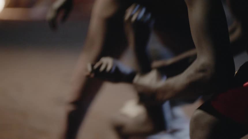 Several children fight outside at night