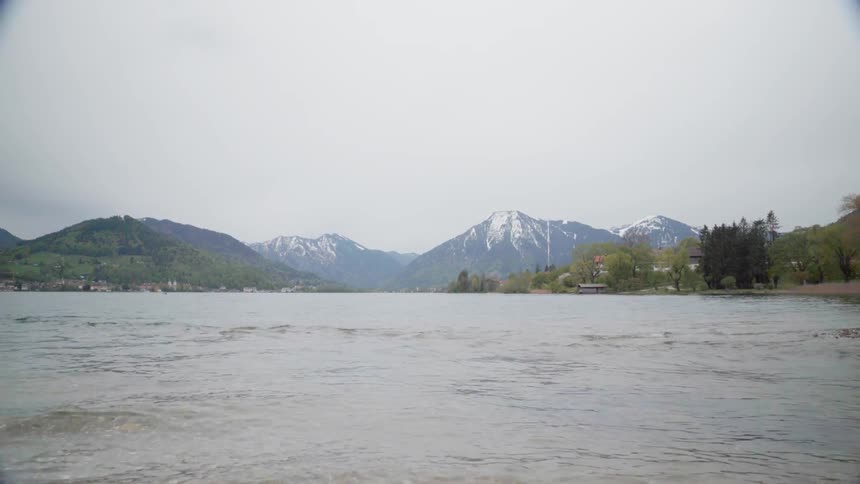 The lake water ripples as it sits near the hills