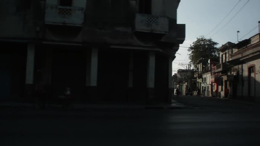 Buildings line the streets as the sun sets