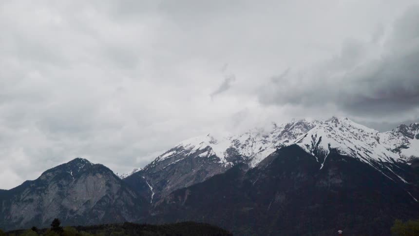 Snow covered mountains under a cloudy sky