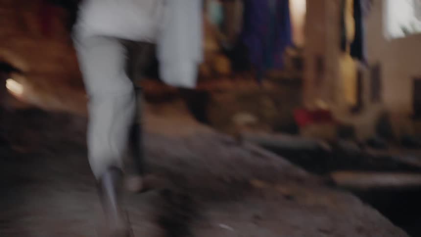 A person is running in the village at night