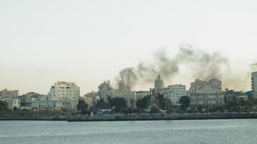 Smoke floats above city buildings