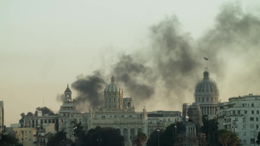 Smoke pours into the sky from the city