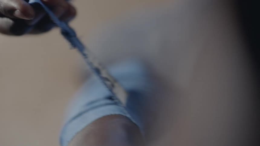 A boxer is wrapping his hands in tape