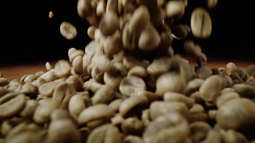Coffee beans fall onto a table