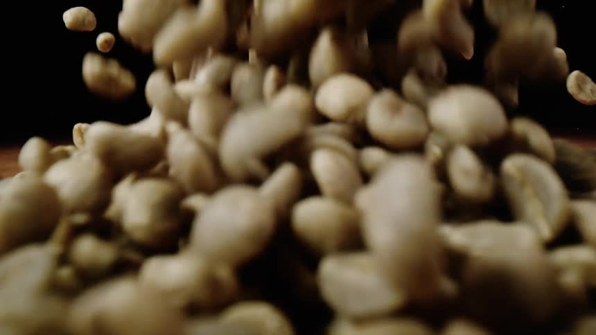 Coffee beans are falling onto table