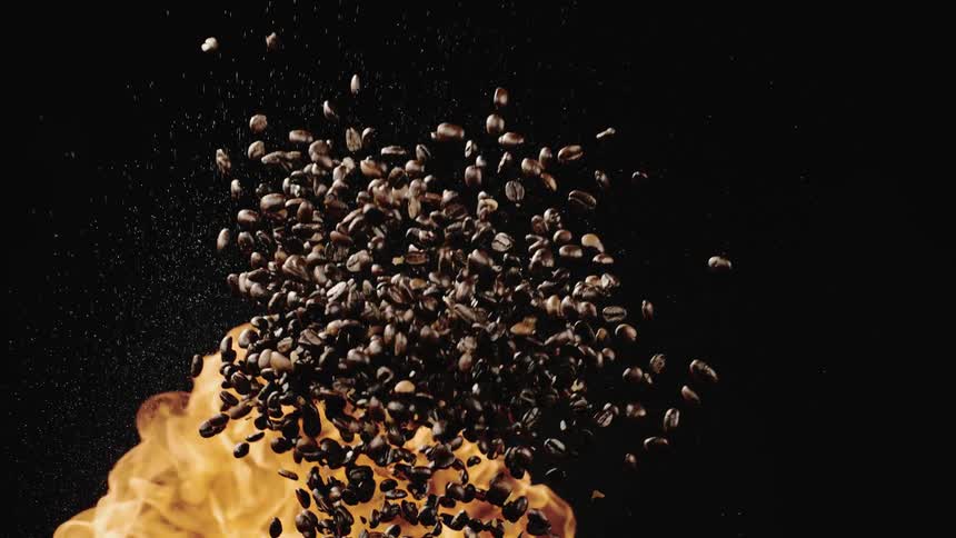 Coffee beans fly through the air near a flame