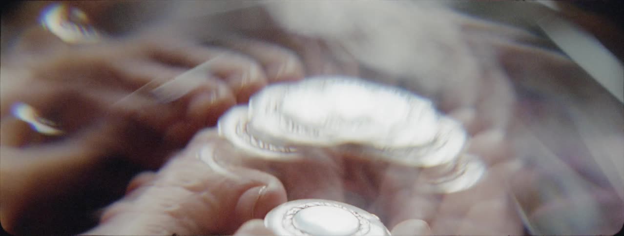 A woman holds a trinket in her hands