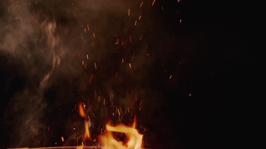 The fire rises up giving off smoke
