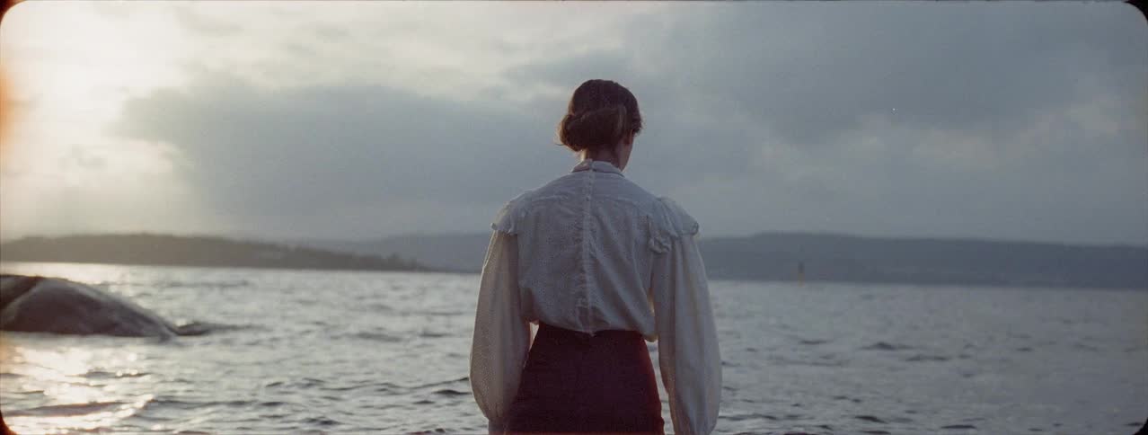 A fully clothed woman walks in a lake