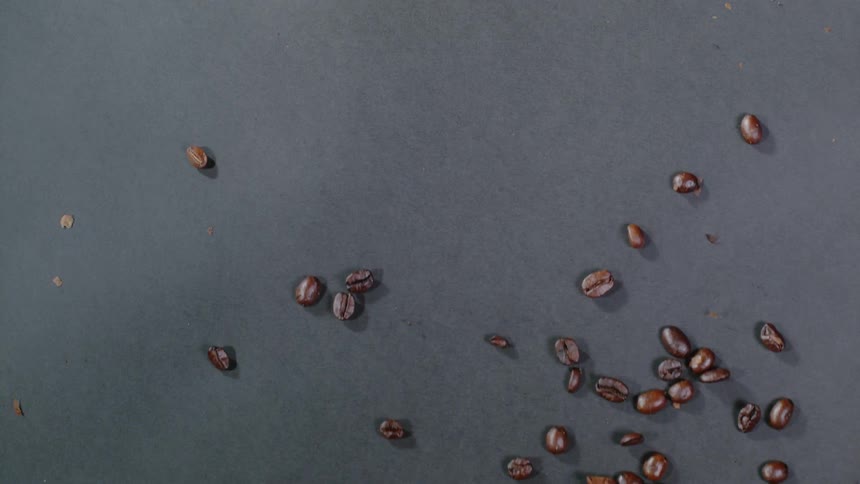 Coffee beans slide across a surface