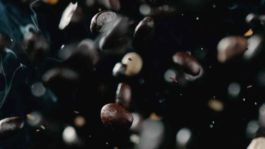 Coffee beans are tossed in the air