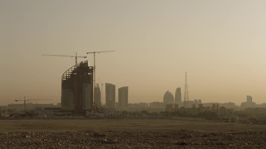 Skyscrapers stand in a city at sunset