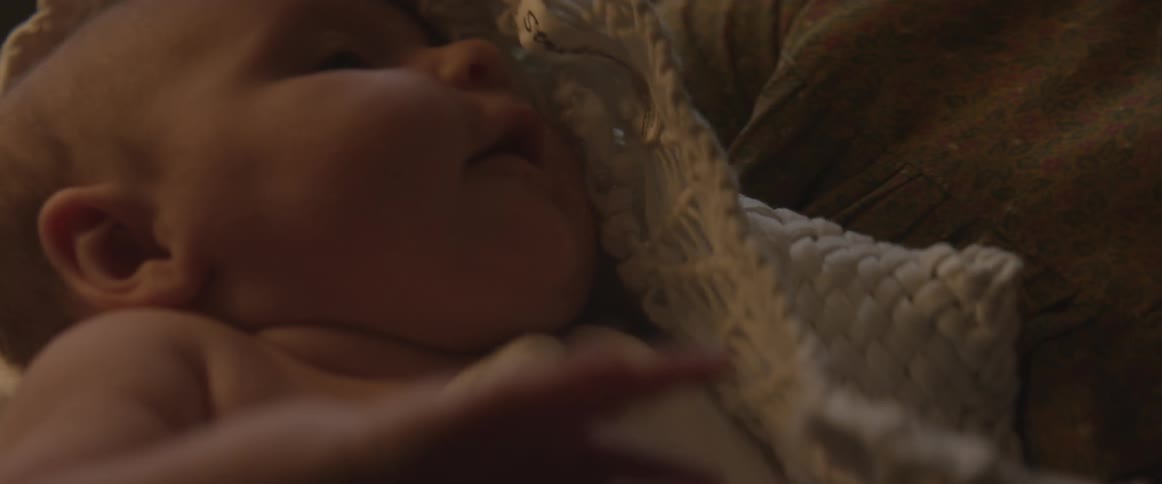 Babe being held by a person moves arm around