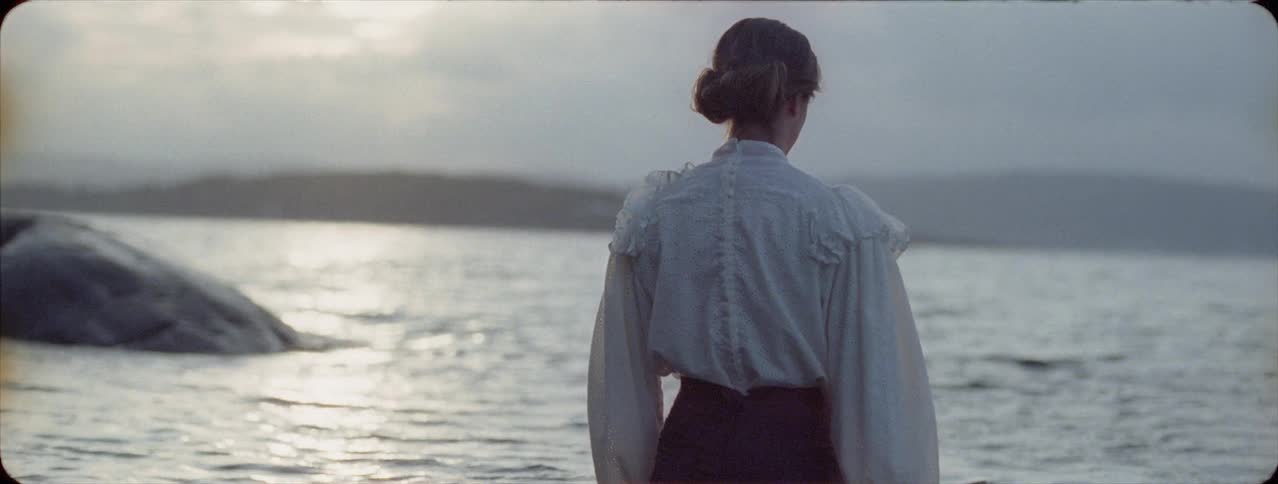 Fully clothed woman walks in a lake