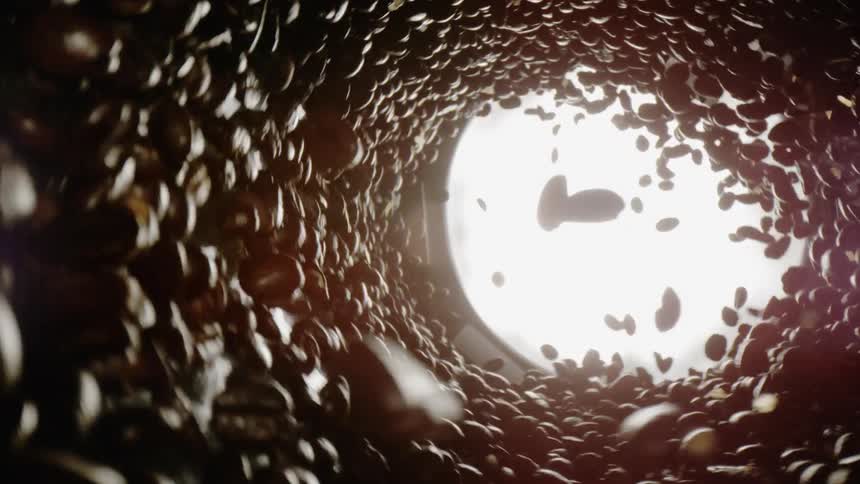 Coffee beans swirl in a cylinder