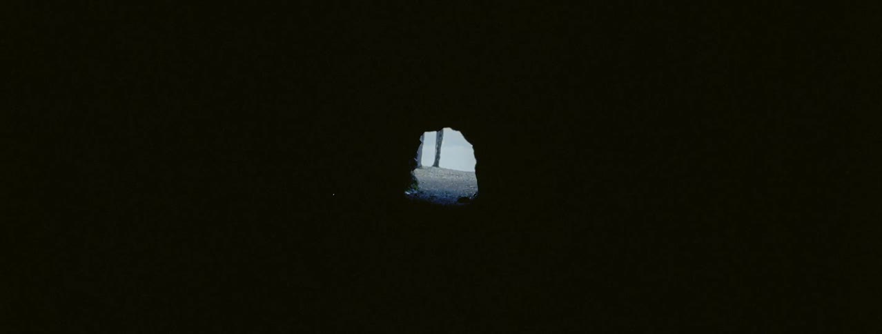 A hole sits at the end of a dark tunnel