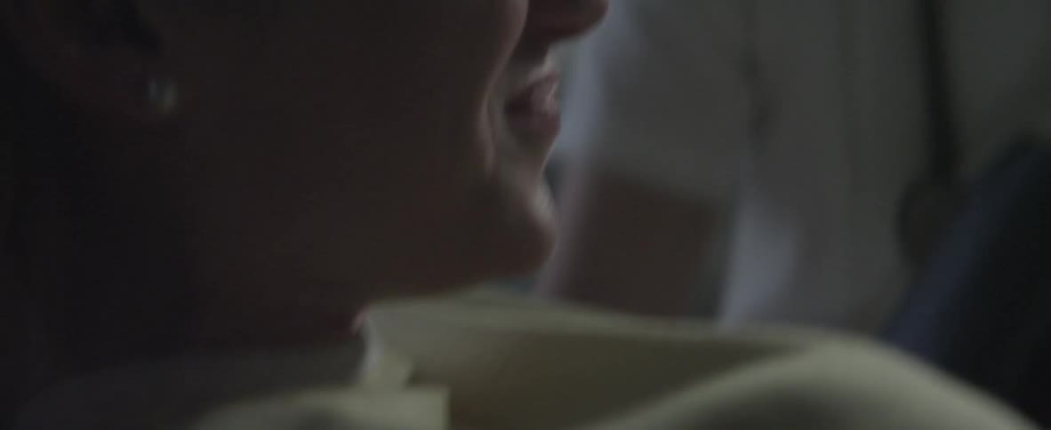 A nurse talks to and holds the hand of a woman in labor