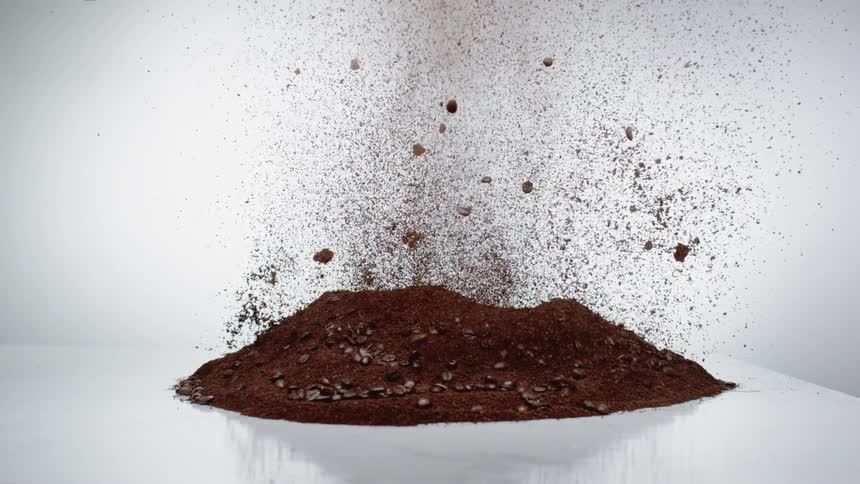 The coffee grounds explode on the table