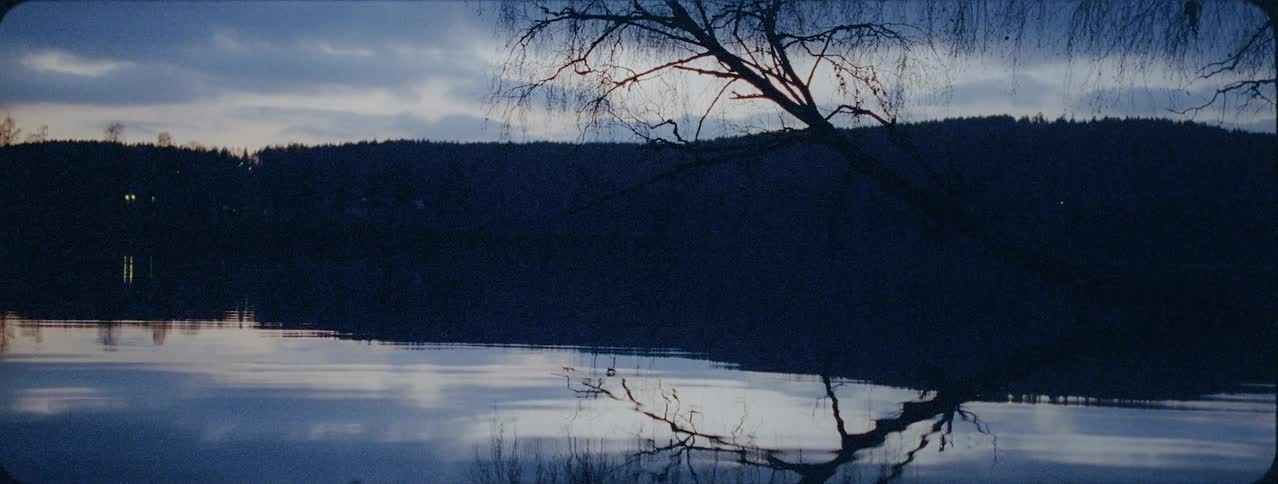 Water is gently rippling in lake after sunset