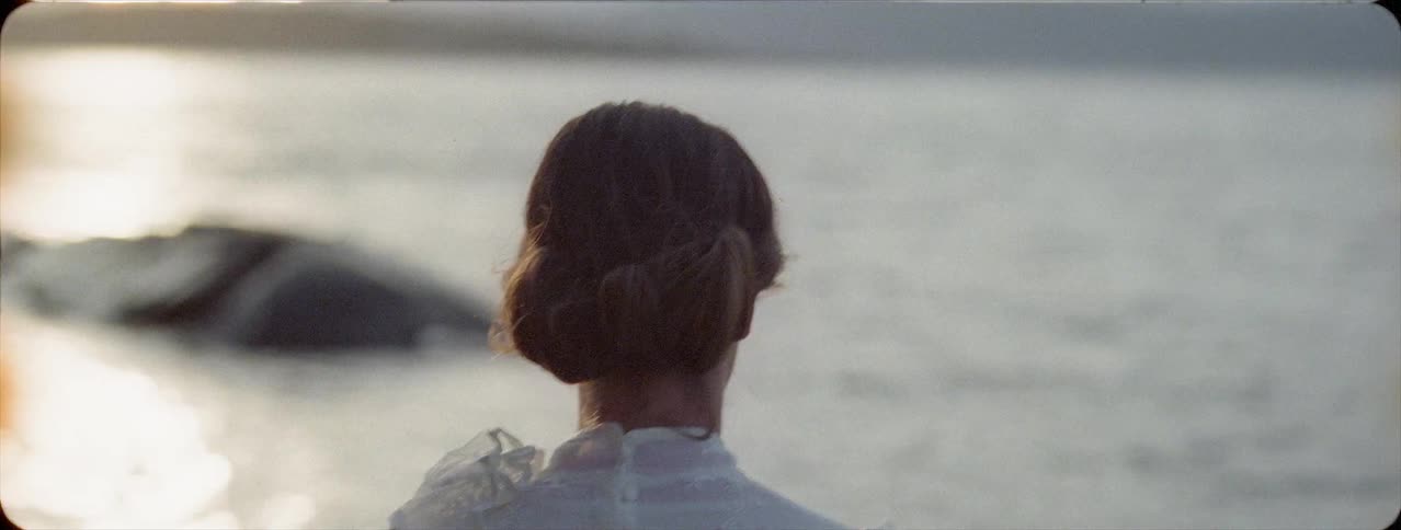 Woman is walking toward a lake