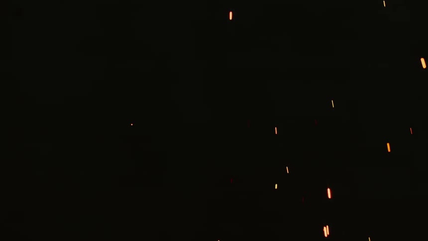 Sparks are shooting into the air in the dark