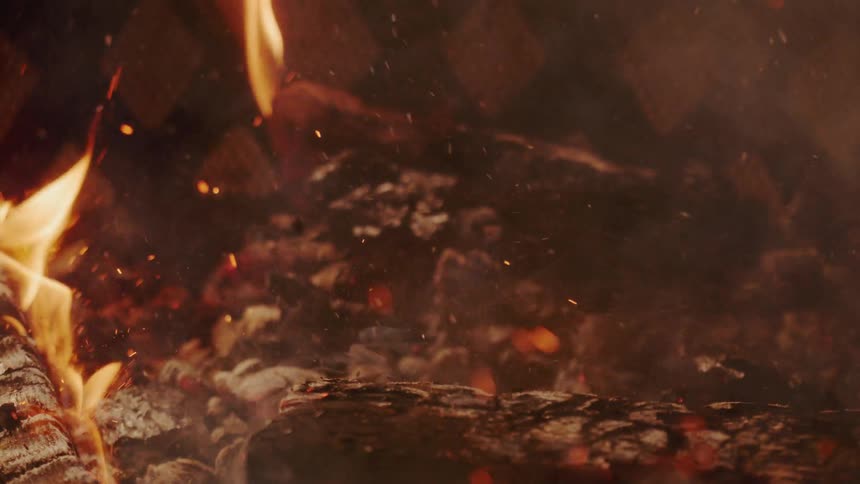 Burning wood crashes to the ground