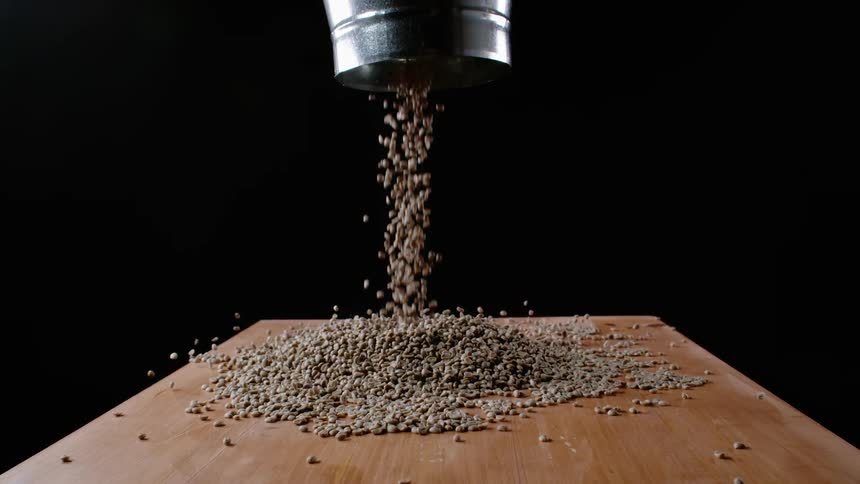 The coffee beans are poured onto the table