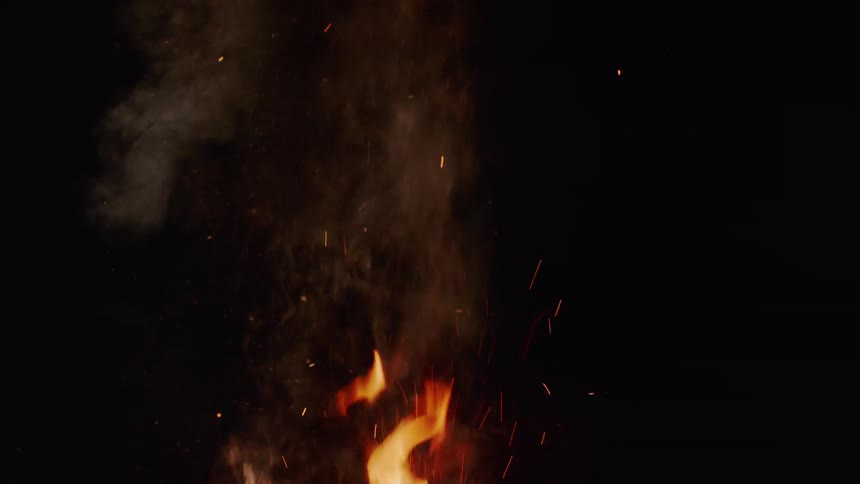 A fire burns in the dark